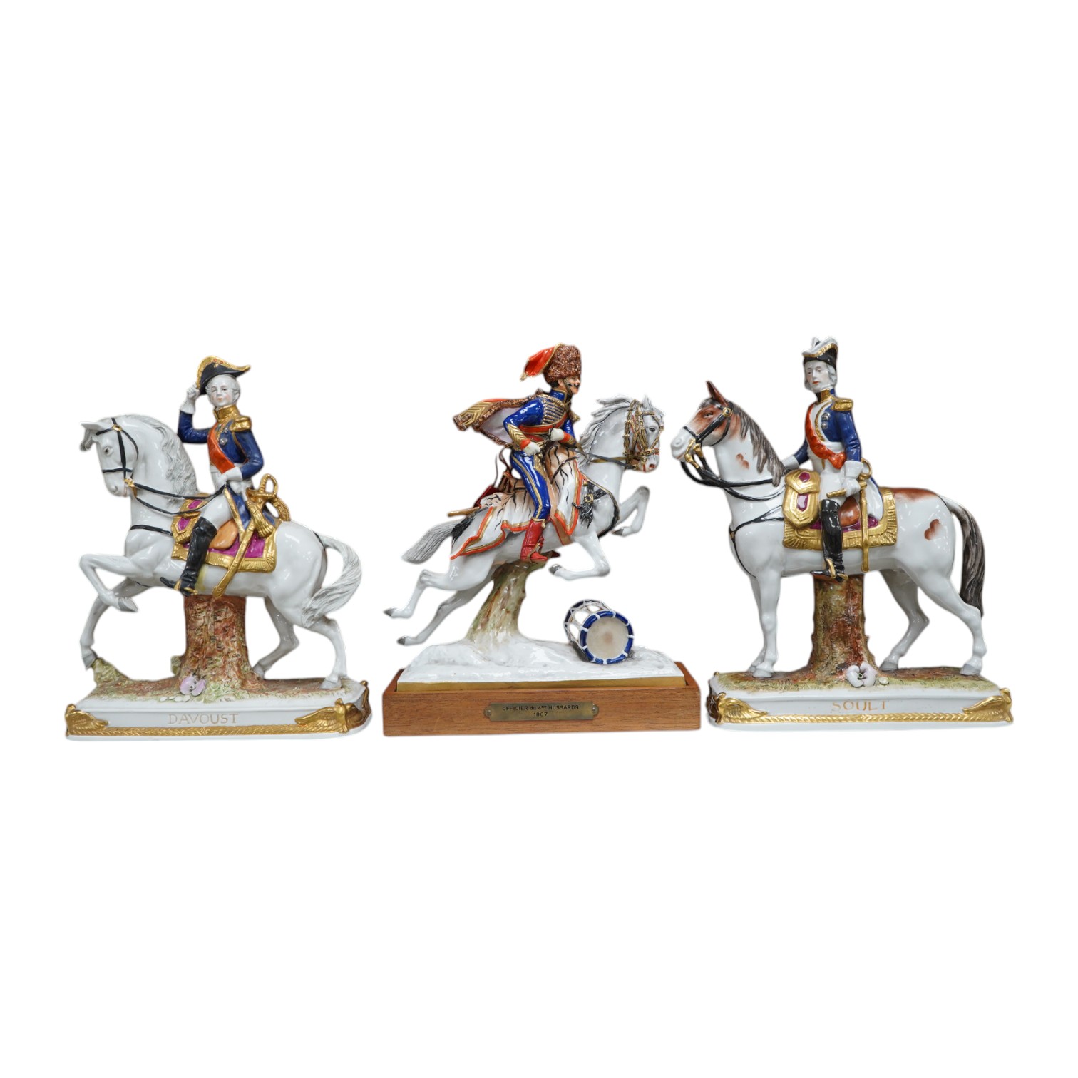 A group of three continental porcelain models of riders on horseback, tallest 27cm